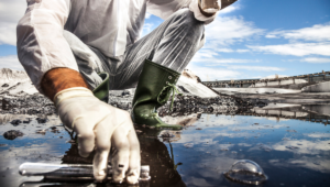 Image of employee collecting a sample of soil and water for a PFAS test